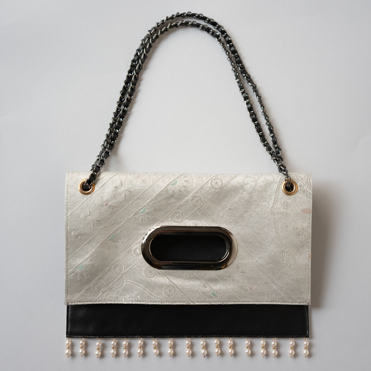 Clutch bag with platinum foil crest and Akoya pearls