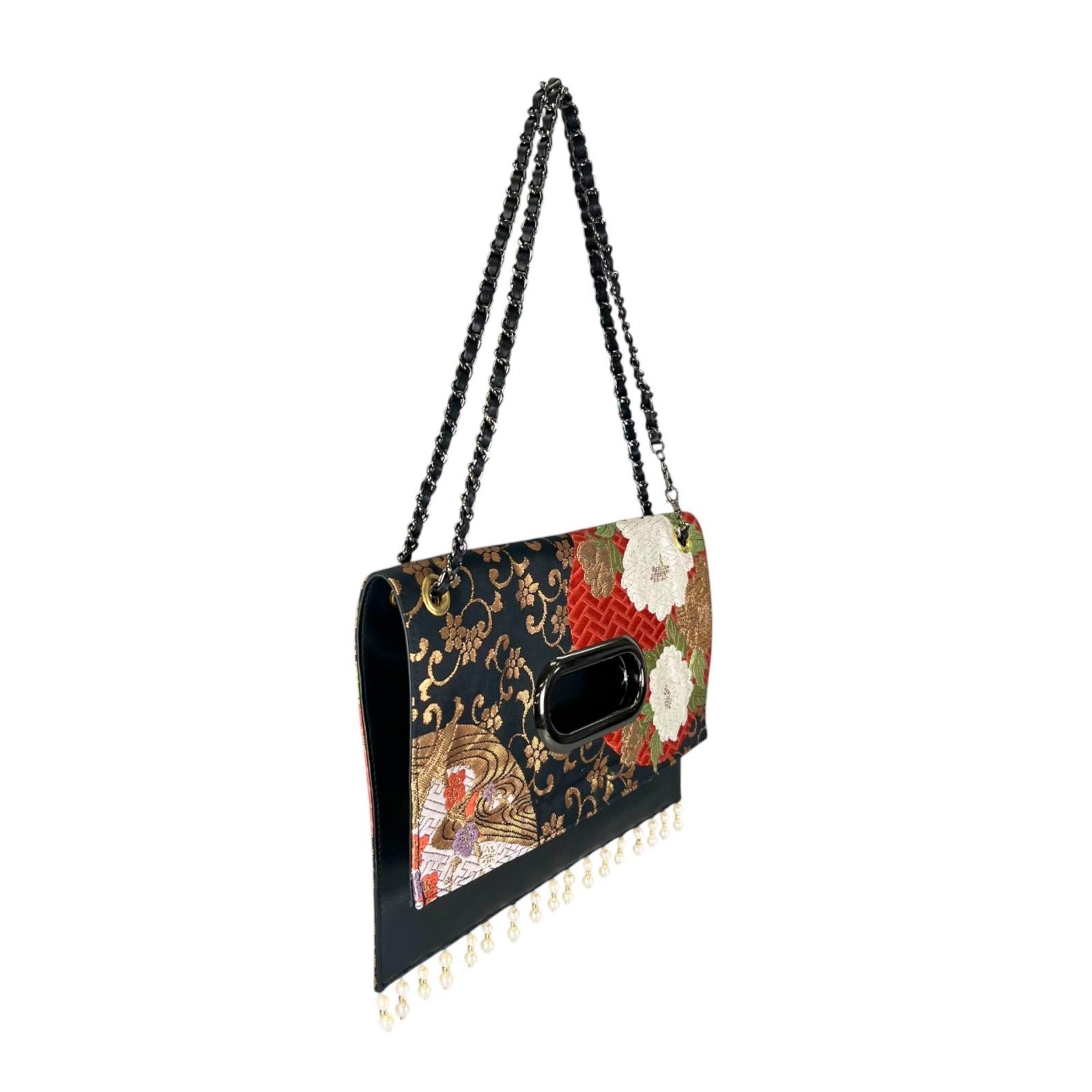 Clutch bag crafted from a vintage obi, adorned with the brilliance of the wisteria crest.