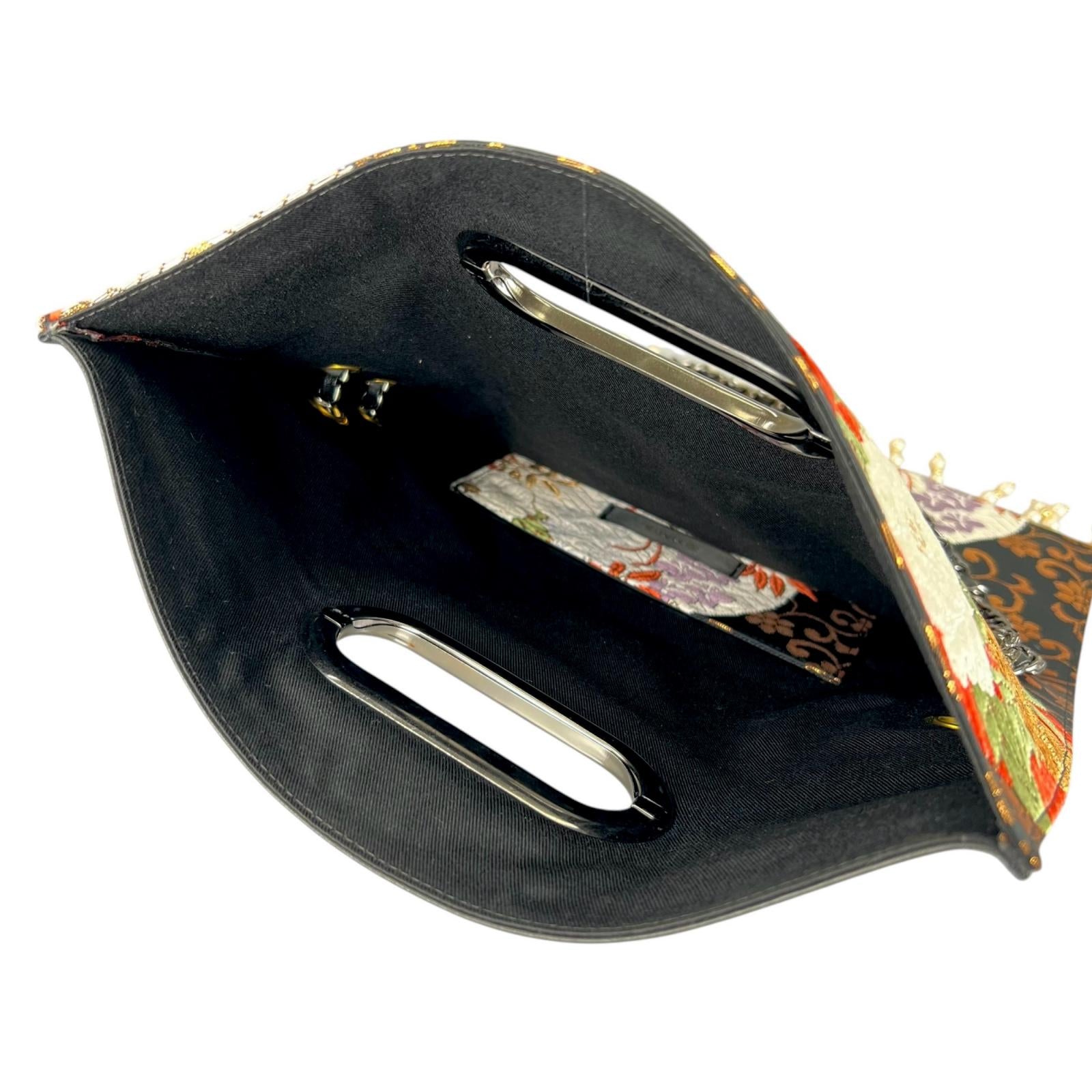 Clutch bag crafted from a vintage obi, adorned with the brilliance of the wisteria crest.