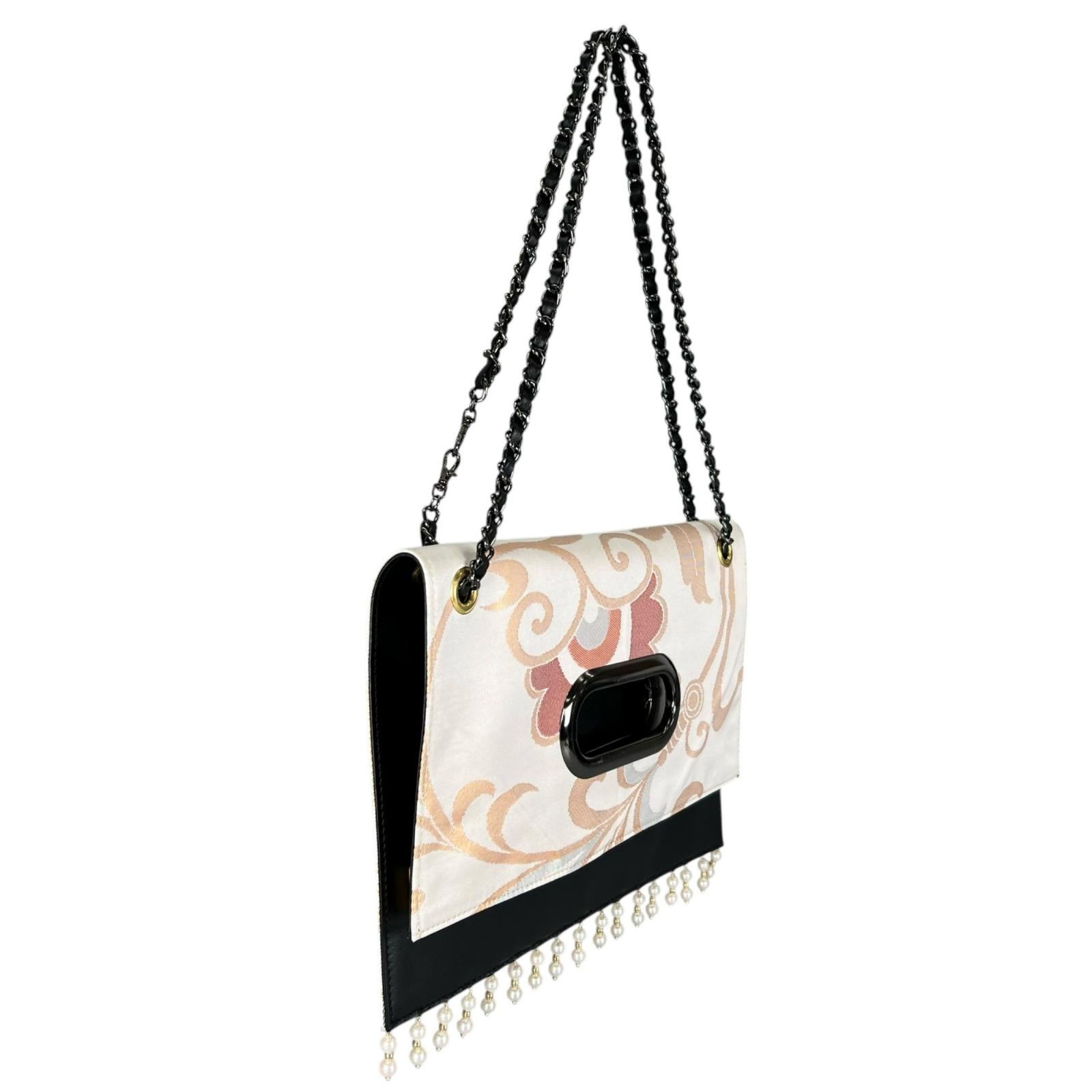 A Clutch Bag made from a vintage obi, breathing new life into a floral arabesque pattern.
