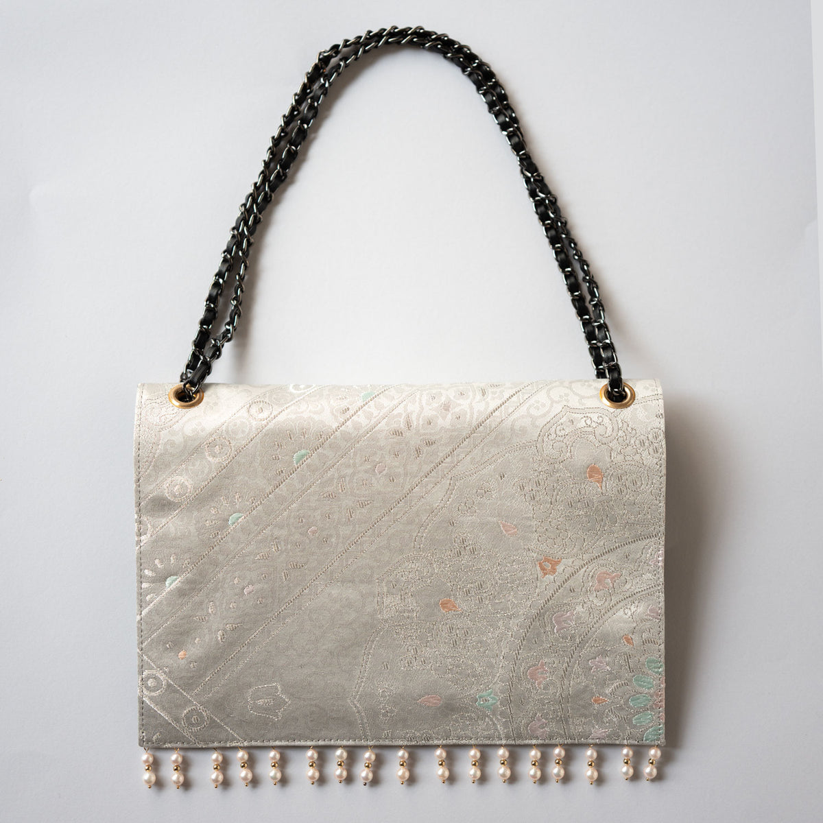 Clutch bag with platinum foil crest and Akoya pearls